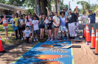 People enganging in crosswalk mural activities